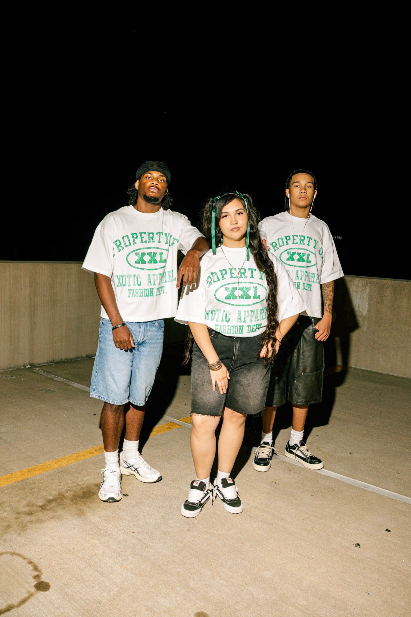 Green "Property of Xotic Apparel" tee
